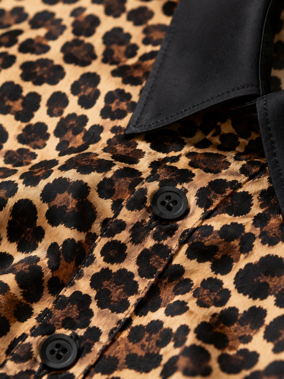 Close detail of the leopard shirt collar and buttons